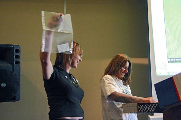 Naomi Andrew, Liz Armstrong, revealing more fabulous raffle prizes,  | DSTC Farewell Symposium, 28 July 2005  | 