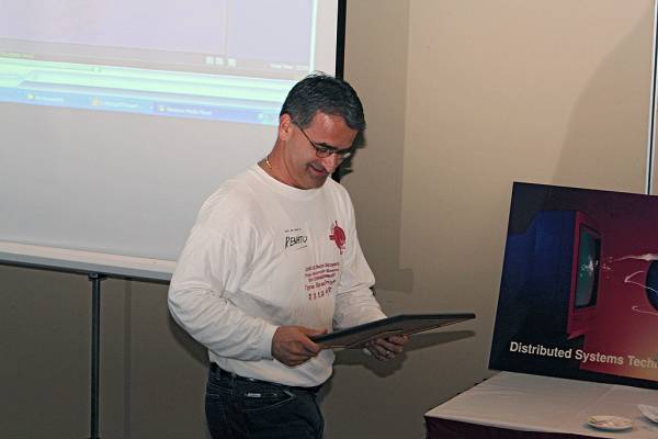 Renato Ianella wondering what he is going to do with David Barbagallo's farewell address,  | DSTC Farewell Symposium, 28 July 2005  | 