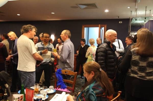 Everyone talking, Kerry Raymond, seated, doing the accounts  | 