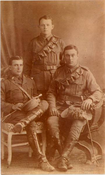 Archibald (Archie) Hewland RAYMOND (left, seated)  | with two friends after enlisting with the  | Australian Imperial Forces in World War 1  |   |   | 