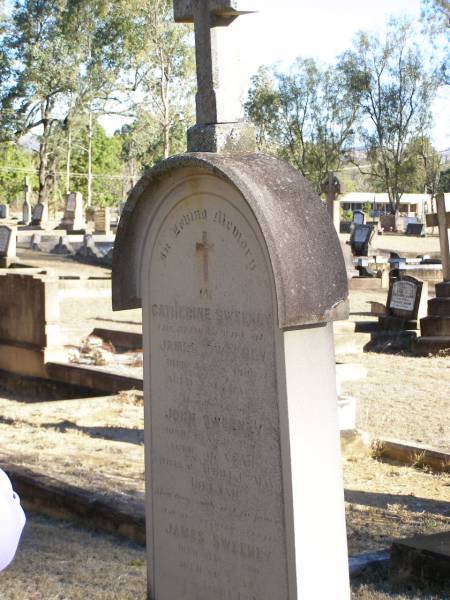 Catherine SWEENEY,  | wife of James SWEENEY,  | died 8 Jan 1906 aged 68 years;  | John SWEENEY, son,  | died 26 Jan 1905 aged 36? years,  | native of Achill? Mayo Ireland,  | James SWEENEY, husband,  | died 7 May 1910 aged 80 years,  | native of Achill? Co Mayo Ireland;  | Helidon Catholic cemetery, Gatton Shire  | 