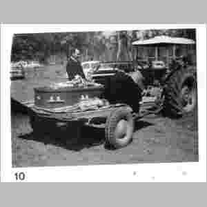 Wivenhoe Pocket Cemetery: Funeral arrangements were adjusted to suit the weather conditions. In this case a tractor was used to negotiate muddy tracks to the cemetery at the funeral of  | Annie MacDonald, aged 86 on 9/3/1976.  | Mr Len Russell, the Undertaker, with the Rev Pete Gillies beside the coffin. (K. MacDonald)  | [Research contact:  Vale Wivenhoe: the story of the Wivenhoe Pocket Church from 1881 to its closing, August 19, 1990. Held by State Library of Queensland (John Oxley Collection)  |   | 