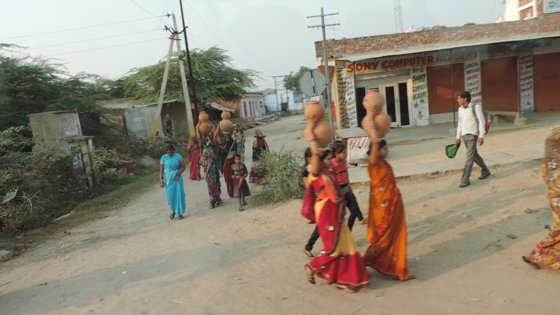 women carrying earthenware pots on their heads