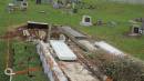 War graves being modified to have grass surround rather than concrete. Norfolk Island cemetery  