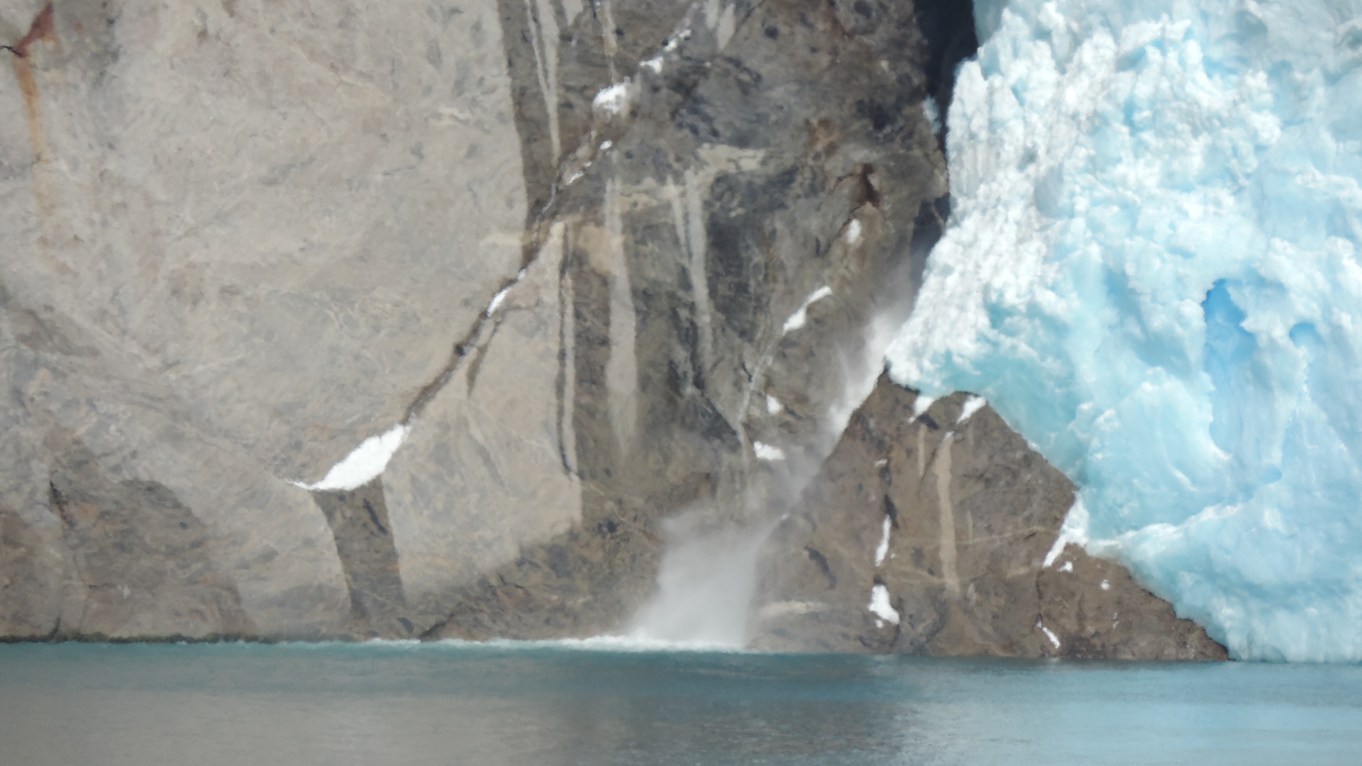 waterfall behind glacier