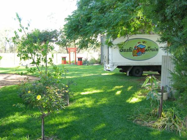 Gardens and Sushi Train truck  | (no, I can't explain that)  | at the historic Riverside Motel,  | formerly Telegraph Hotel,  | Bourke, New South Wales  | 