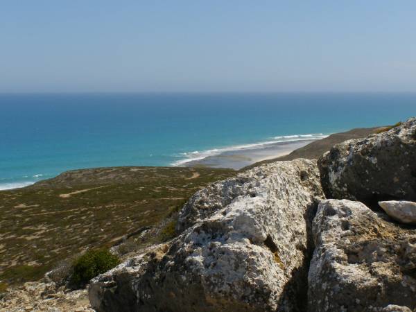 Rocky hillsides lead down to  | the Great Australian Bight,  | Nullarbor Plain,  | Eyre Highway,  | South Australia  | 
