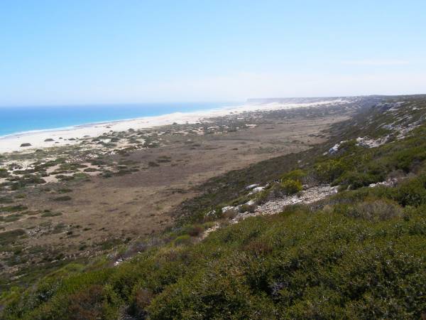 Rocky hillsides lead down to  | the Great Australian Bight,  | Nullarbor Plain,  | Eyre Highway,  | South Australia  | 