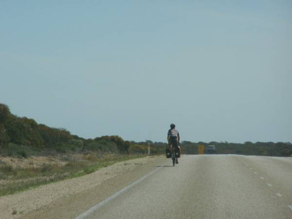 Cyclist crossing the Nullarbor Plain,  | near Border Village,  | Eyre Highway,  | Western Australia  | 