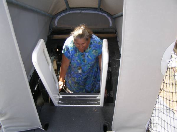 Kerry climbing out of the submarine HMAS Ovens,  | Maritime museum,  | Fremantle,  | Western Australia  | 
